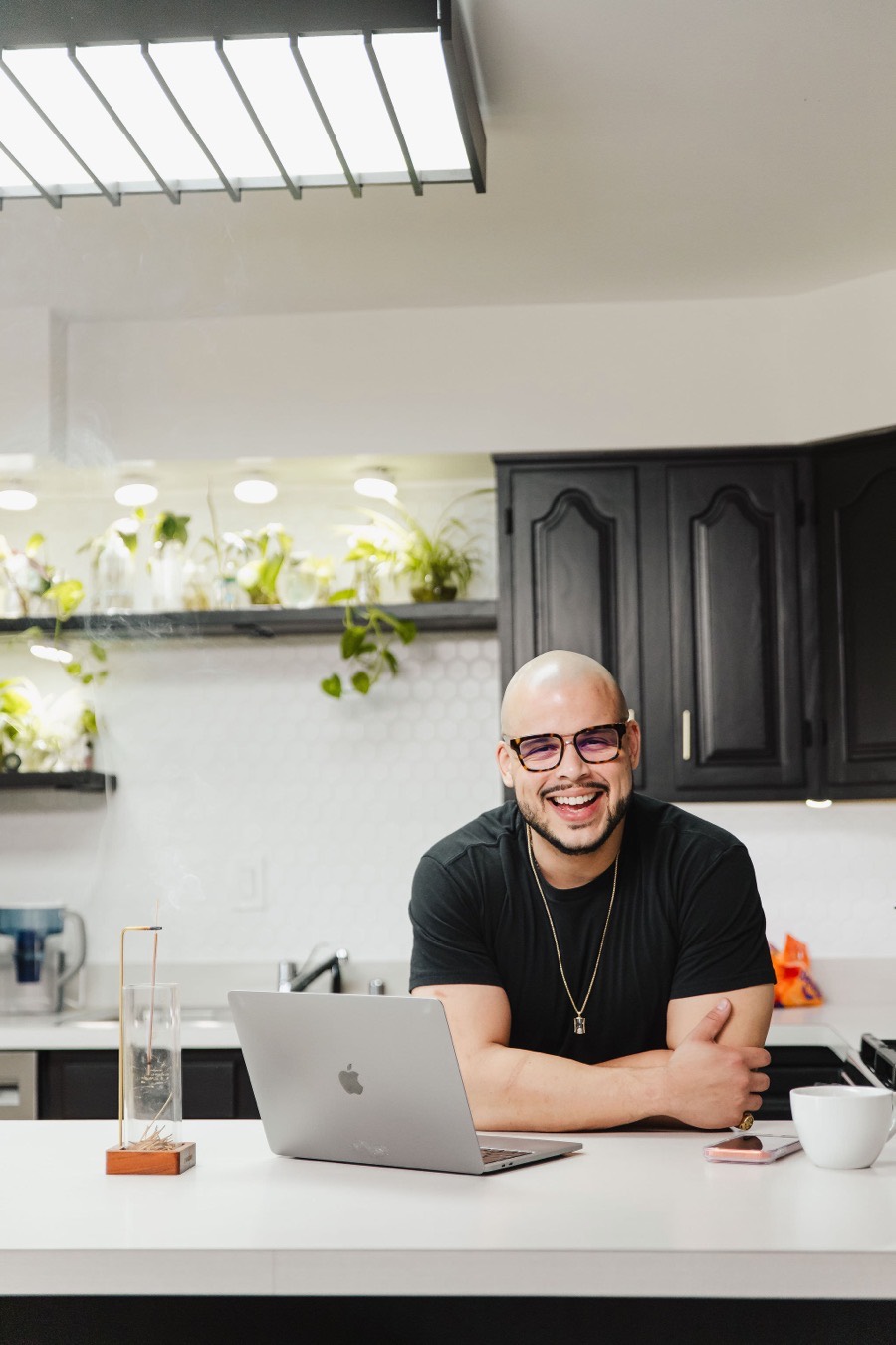 Willis Aybar, founder of the Another Monday marketing studio, working at his kitchen counter in Baltimore, MD