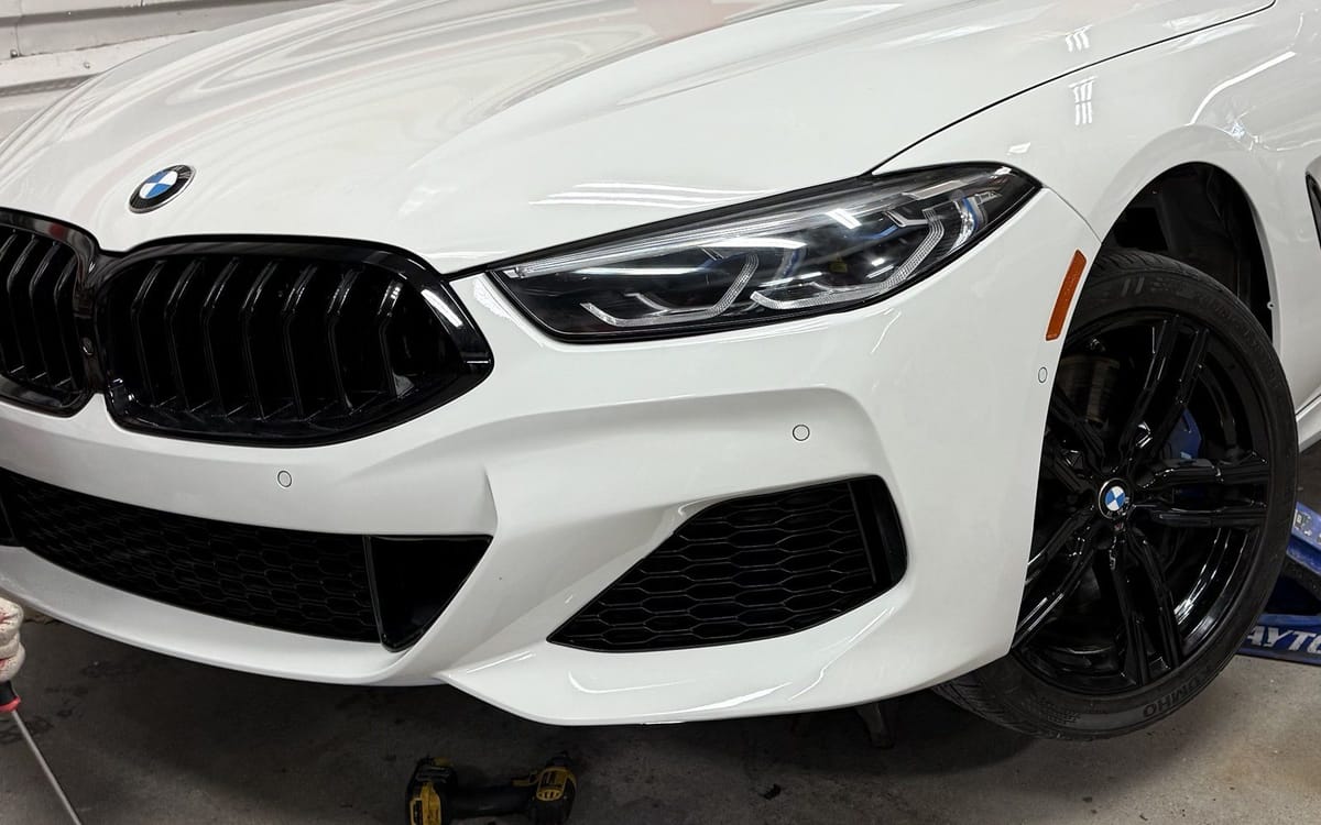 The same white BMW 8 Series front end rebuilt and refinished at Exclusive Collision and Repair in Brooklyn, New York