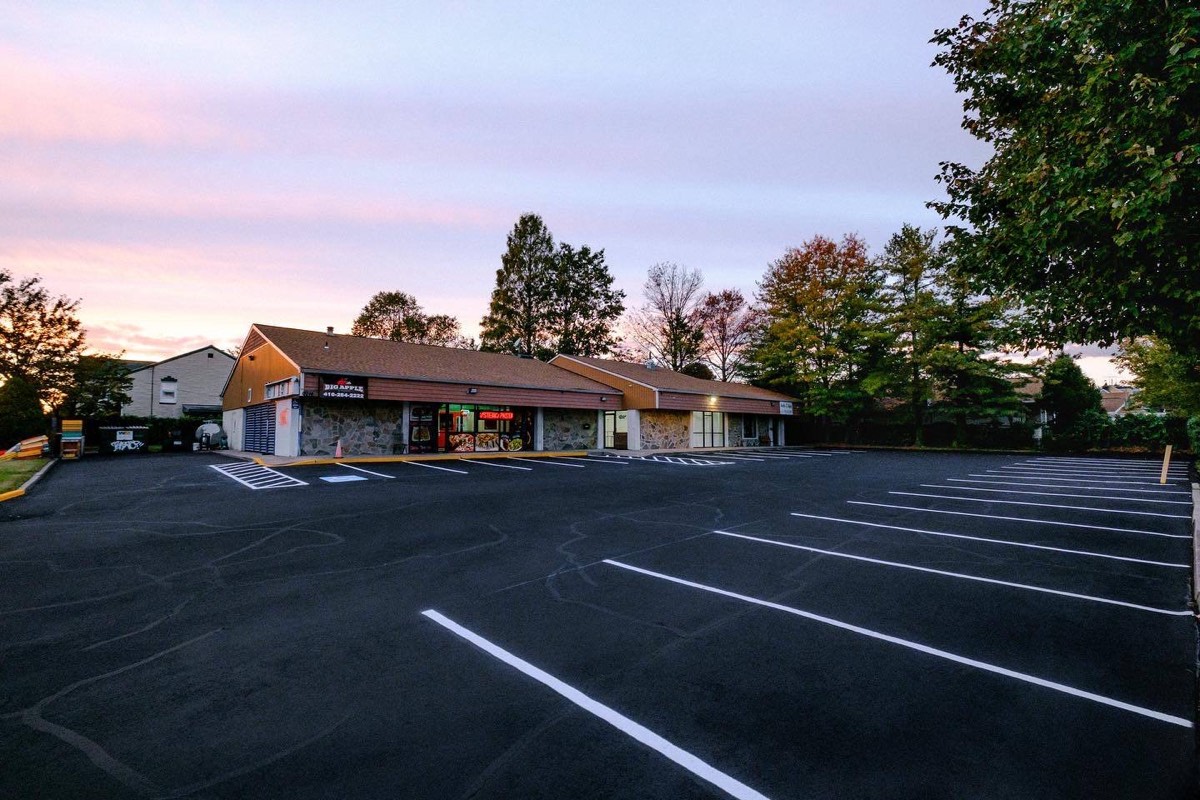 The Studio 87 storefront at dusk in Dundalk, Baltimore, a small business on a strip of shops that had to be findable before anyone walked in