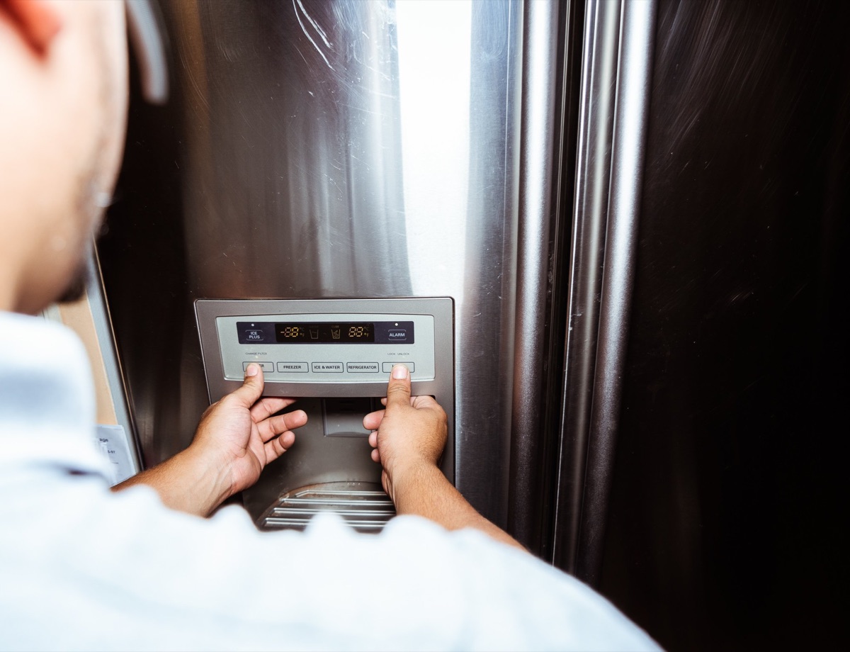 A Doctor Maintenance technician diagnosing a refrigerator control panel in Baltimore, the appliance repair client whose search ambitions outgrew Squarespace