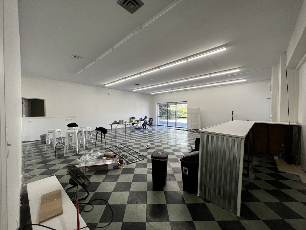 Studio 87's Baltimore event space mid build-out, tables and stools going in, the kind of setup day I filmed for social while the venue was still being finished
