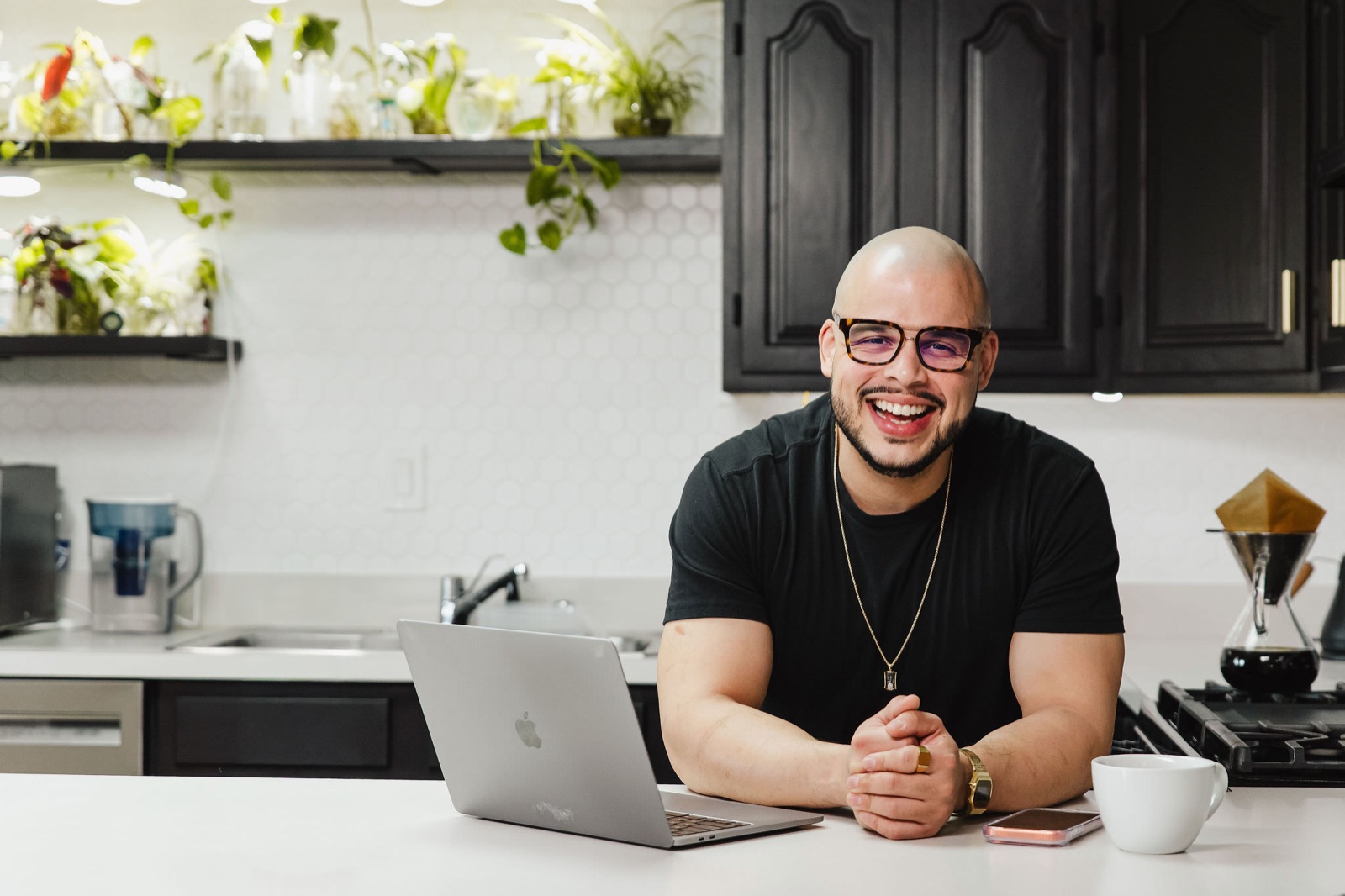 Willis Aybar, founder of the Baltimore marketing agency Another Monday, working on a laptop at his kitchen counter