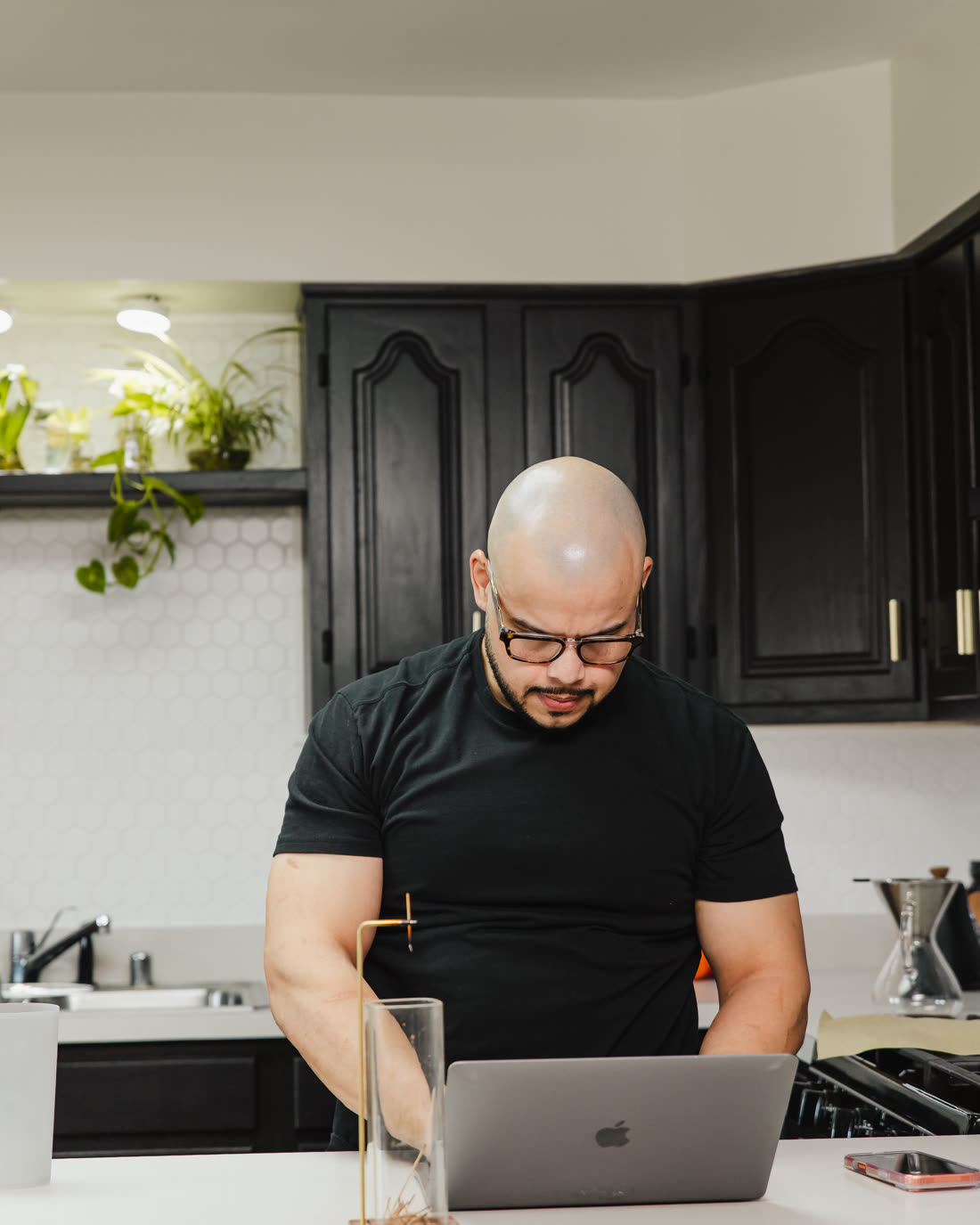 Willis Aybar of Another Monday working at his laptop at the kitchen counter in Baltimore, MD, where he runs the agency on Google Workspace for small business