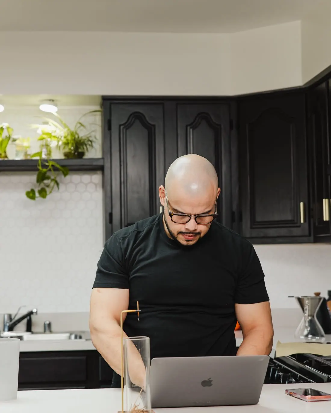 Willis Aybar of Another Monday working at a laptop, the Baltimore operator who has built websites on Wix, Squarespace, WordPress and custom code